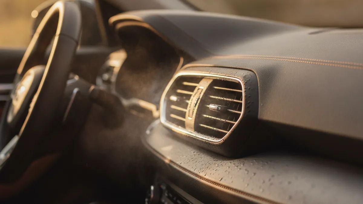 Car AC vents in the cabin blowing cold air on a hot summer day